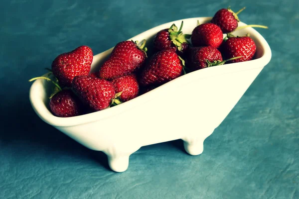 Strawberries in minature bathtubs