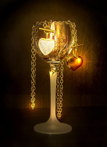 Glass of wine and gold heart necklace