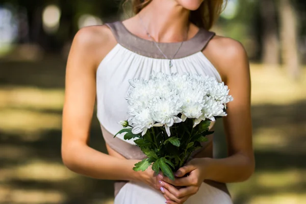 Beautiful  young girl with a bouquet of flowers