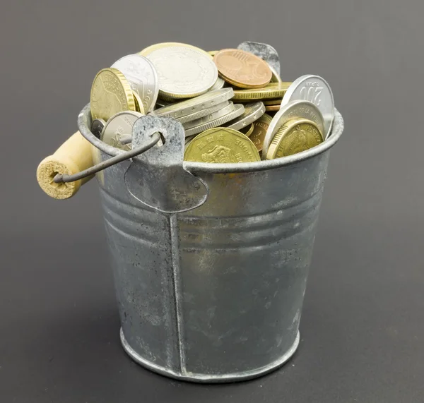 Natural little old metal bucket with coins