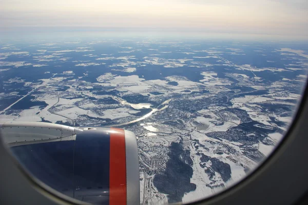 View from airplane over the city in winter