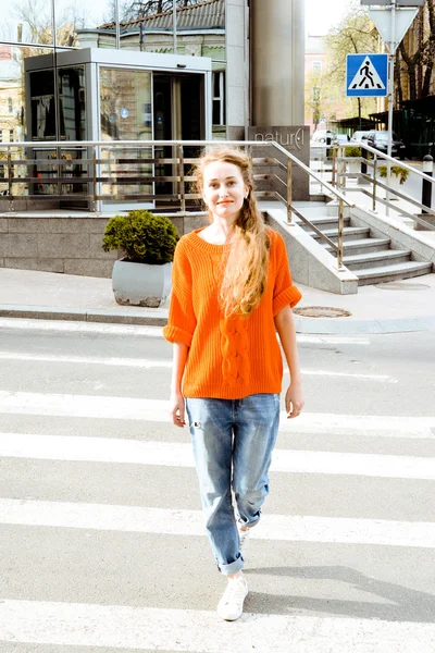 Young beautiful long-haired hipster girl walking.