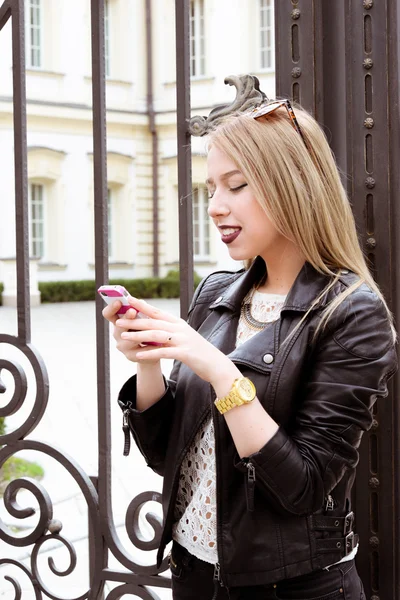 Beautiful blond young hipster girl in leather jacket
