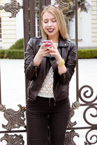 Beautiful blond young hipster girl in leather jacket