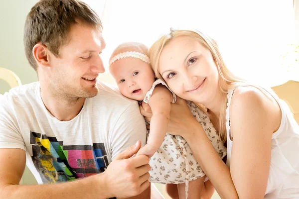 Happy young family spending time outdoors on a summer day.