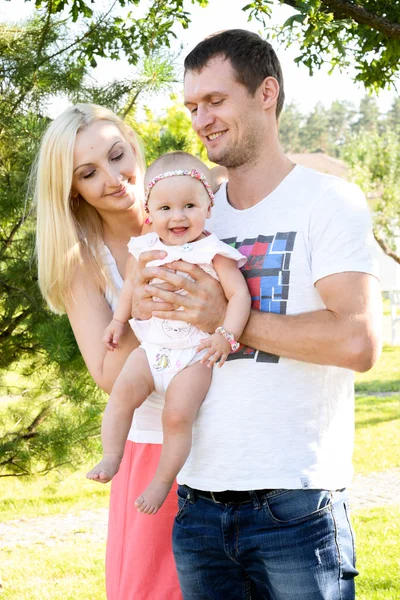 Happy young family spending time outdoors on a summer day.