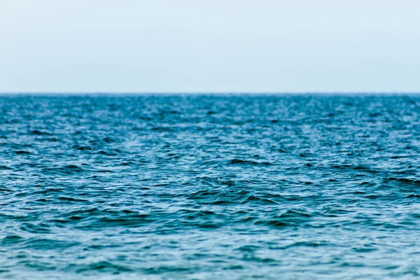 Blue water surface of the lake with depth of field stretches into the horizon