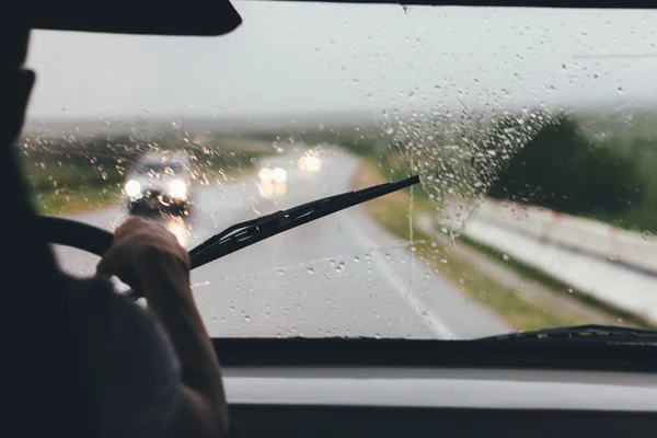 Man driving a car in the rain