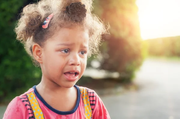 Beautiful sad little girl crying