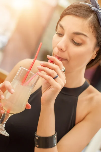 Gorgeous young brunette drinking lemonade