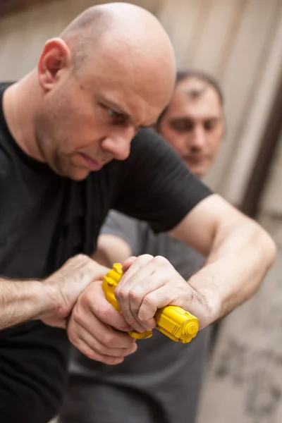 Gun Disarm. Self defense techniques against a gun point.