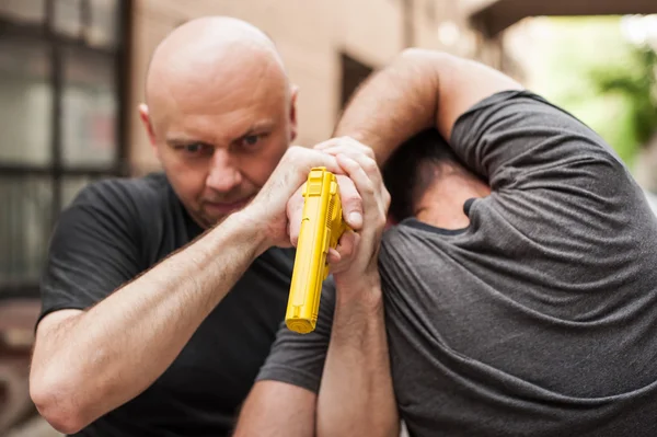 Gun Disarm. Self defense techniques against a gun point.