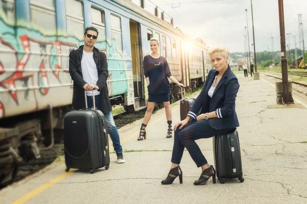 Business people with suitcase posing on the railway station