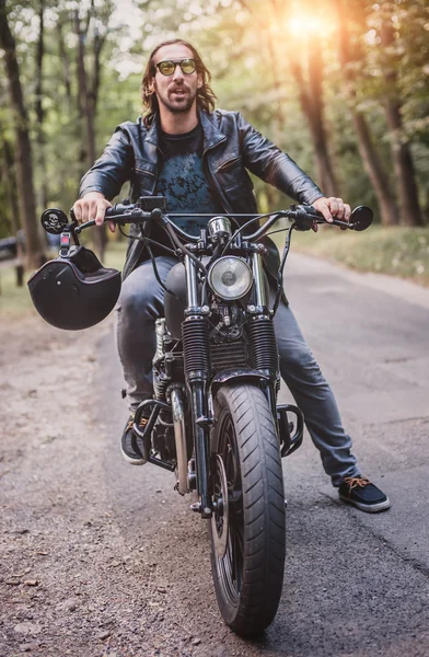 Biker man sitting on his motorcycle