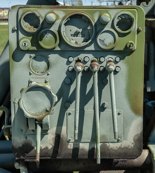 Old control panel with broken glass instruments are painted green paint