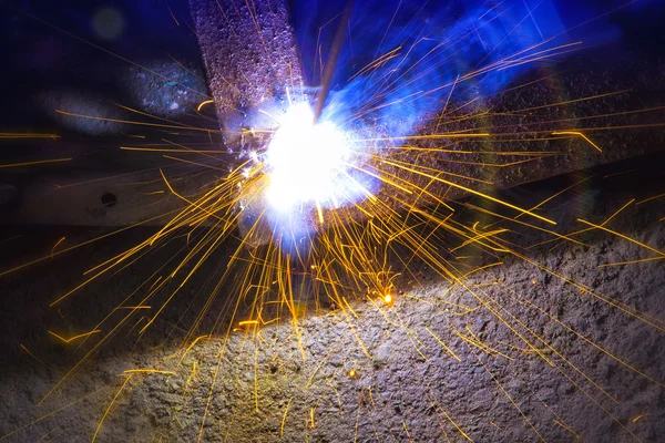 Welding sparks close up. Work welding machine. Metalwork.