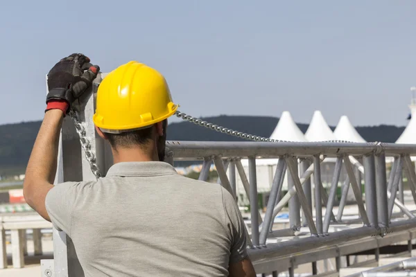 Workers building stage truss construction