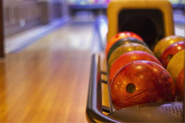 Colorful bowling balls in front of tenpin alley