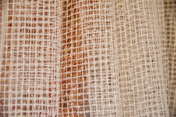 Part of  linen curtain in a window