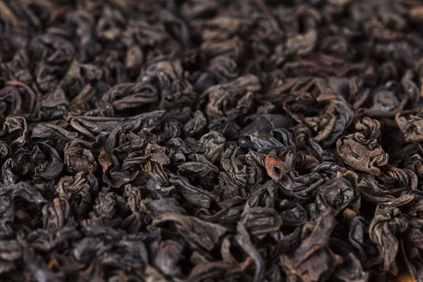 Black tea dry leaves. Macro, background
