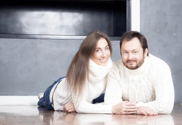 Portrait of husband and wife in white sweaters.