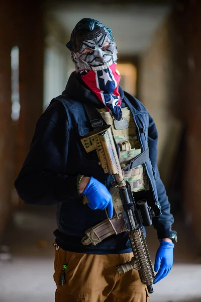 Photo of man wearing mask with gun