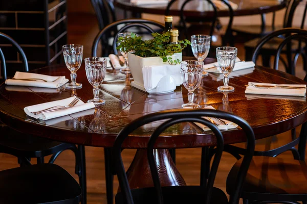 Wooden round table served for dinner in the restaurant