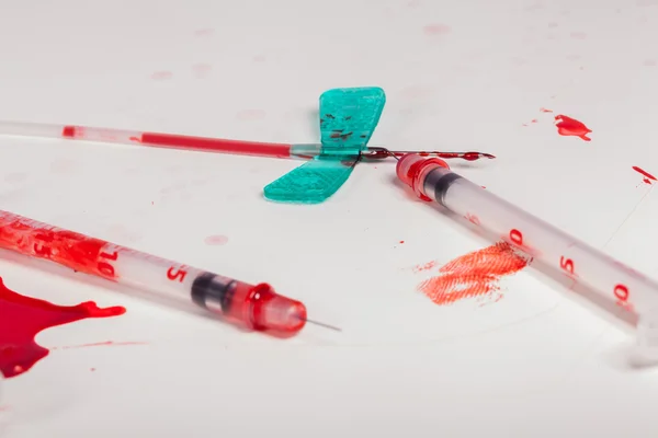 Syringes and IV Lines Covered with Blood