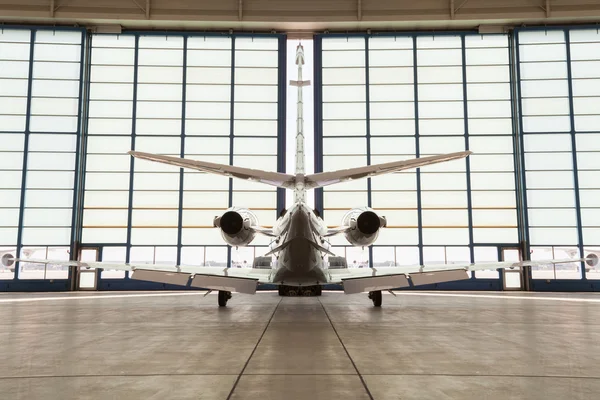 Private corporate jet parked in a hangar
