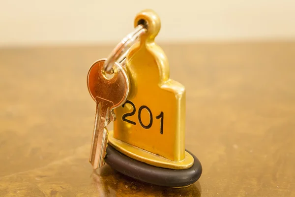 Hotel Room Key lying on Bed with keyring