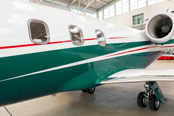 Small private corporate jet in a hangar