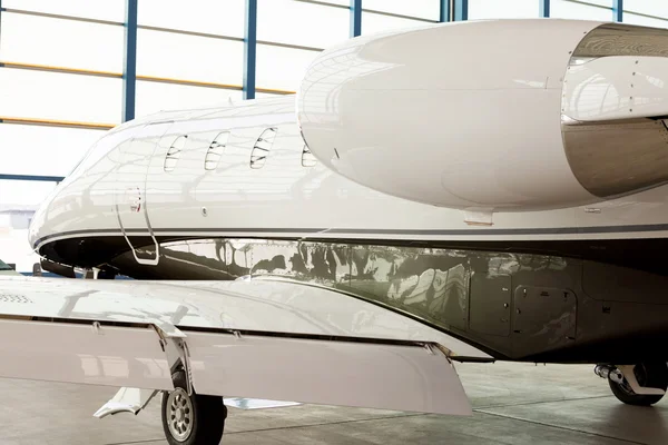Small private corporate jet in a hangar
