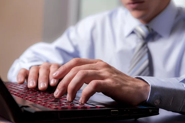 Hands of young man working on the computer.