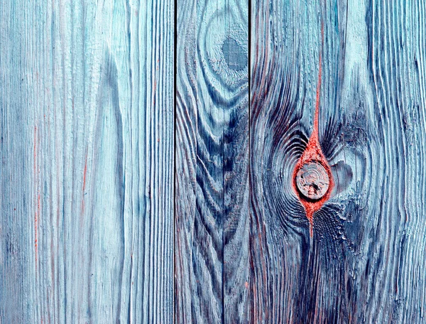 Grungy blue, red streaked colorful wood wall texture background