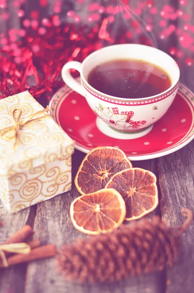 Christmas still life with cup of tea, orange slices and cinnamon, Happy New Year, selective focus, toned photo