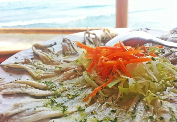 Marinated anchovies with olive oil and garlican carrot