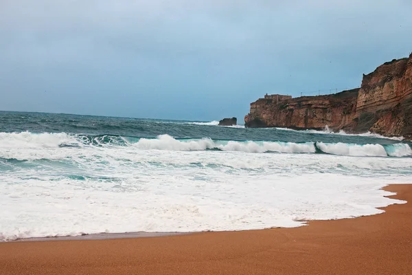 Big waves roll ashore. Atlantic ocean. (Nazare, Portugal).