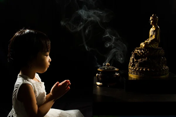 Asian Little Chinese Girl Praying in front of Buddha