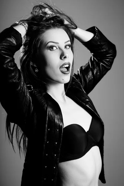 Black and white photography of hot sexy pretty young lady wearing leather jacket sensually looking