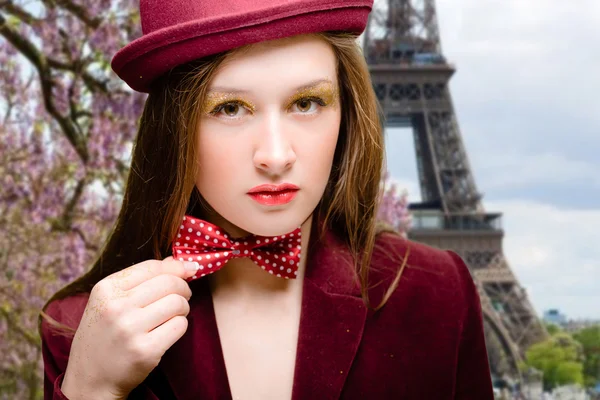 Professional model posing for photographer over Eiffel Tower background