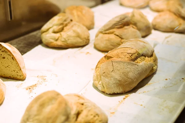 Fresh bread with crust and crumbs on white tabletop background