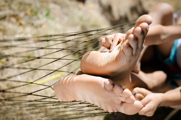 Closeup of family feet tickling and having fun in hammock