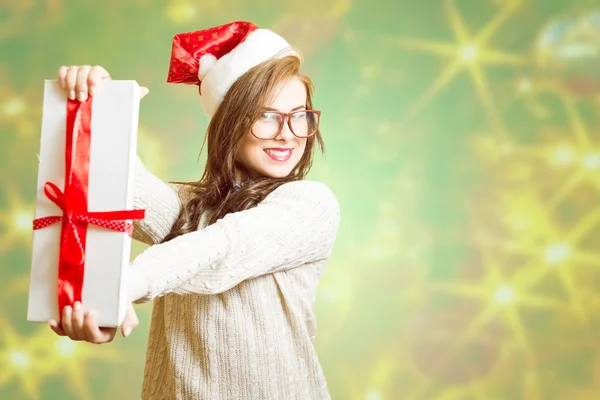Picture of showing gift box beautiful young woman in Santa red hat and glasses
