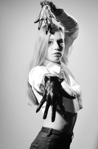 Black and white photography of blonde pretty female in transparent gloves dancing
