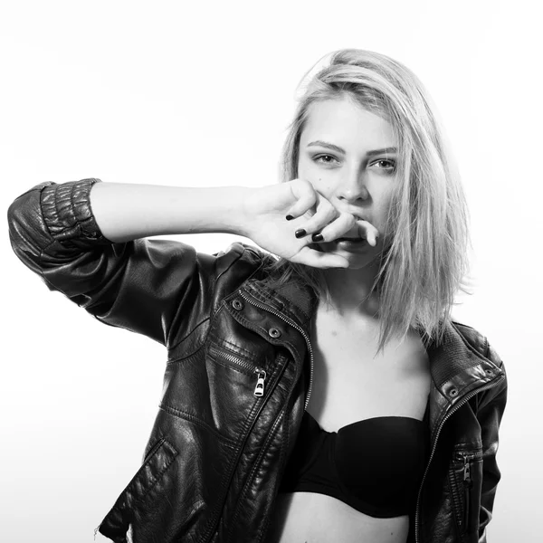 Black and white image of beautiful woman in leather jacket