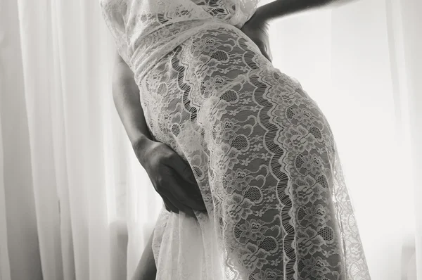 Sexy model wearing white dress, closeup on hips