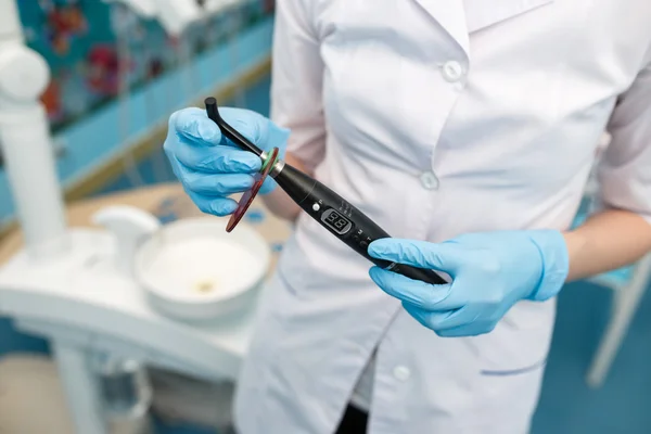 Humor. Dentist holding a human jaw and tooth brush in hand. Funny emotion