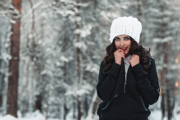 Beautiful young girl in winter forest