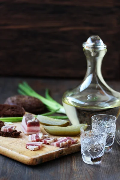 Russian snack - salty bacon (salo) and vodka with rye bread and spring onions