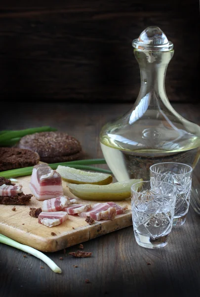 Russian snack - salty bacon (salo) and vodka with rye bread and spring onions